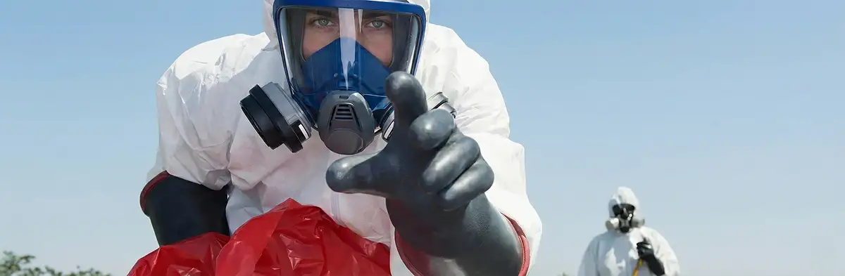 sewage clean up technician wearing protective gear handling biohazard materials in Mesa, AZ