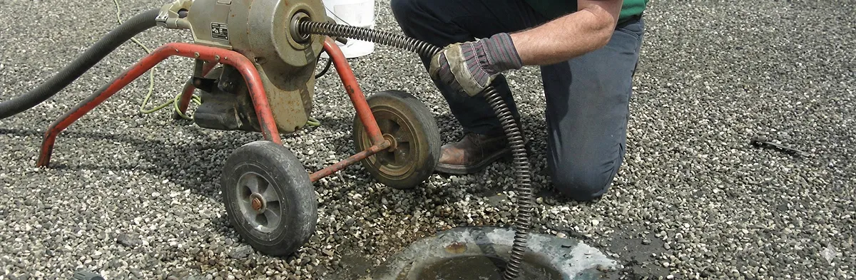 sewer rodding technician actively removing blockages from a sewer line in Mesa, AZ